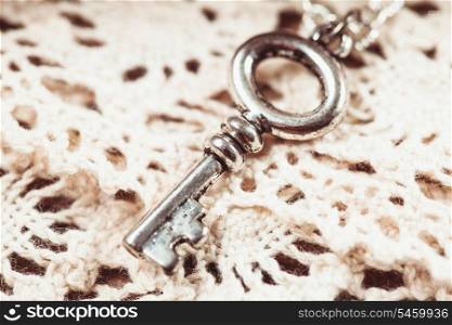 Vintage key on the white aged lace