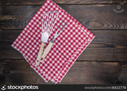 vintage kitchen appliances on a red napkin, empty space on the right