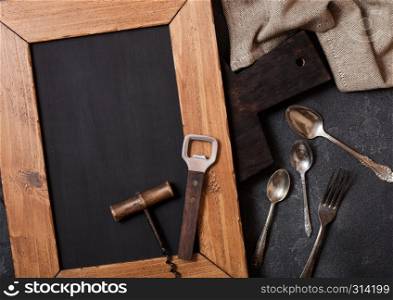 Vintage kitchen wooden utensils with chalk menu board on stone table background. Top view.