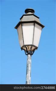 vintage lamp post against blue sky background