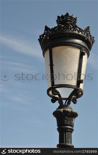 vintage lamp post against blue sky background