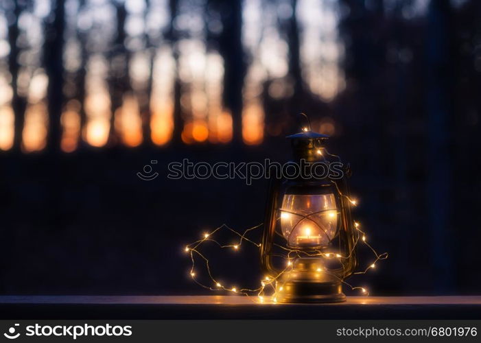 Vintage lamp with a candle and lights at night
