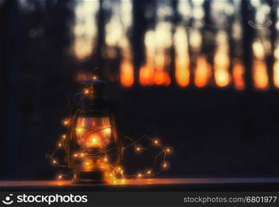 Vintage lamp with a candle and lights at night