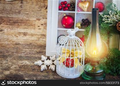 vintage lantern with christmas wreath. vintage burning lantern with christmas decorations on wooden background