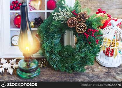 vintage lantern with christmas wreath. vintage burning lantern with christmas wreath and decorations