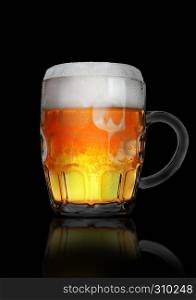 Vintage large glass of beer with foam and bubbles on black background