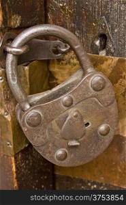 Vintage lock on a old wooden church door.