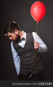 Vintage looking man with red balloon in his hand