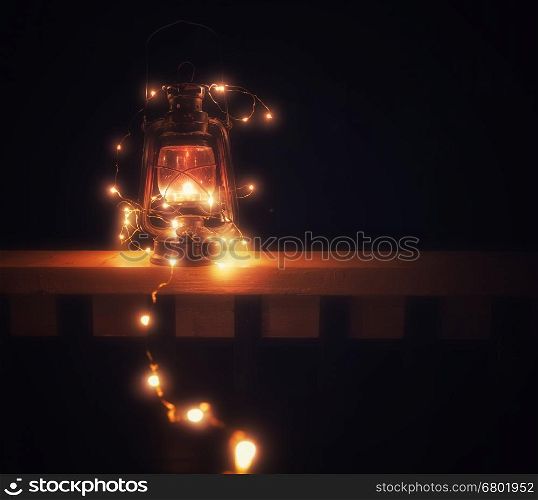 Vintage magic lantern with lights at night