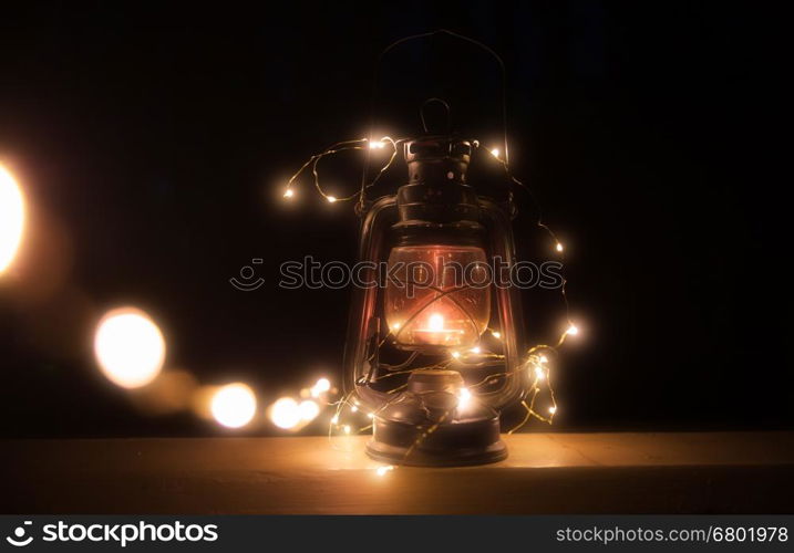 Vintage magic lantern with lights at night