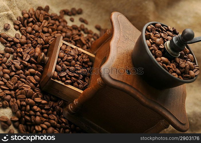 Vintage manual coffee grinder with coffee beans isolated