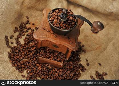Vintage manual coffee grinder with coffee beans isolated