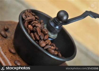 Vintage Manual coffee grinder with coffee beans isolated