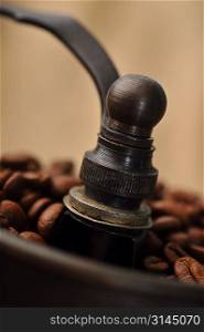 Vintage Manual coffee grinder with coffee beans isolated