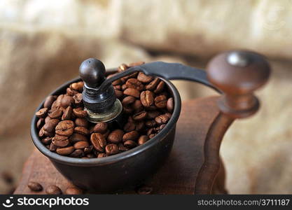 Vintage manual coffee grinder with coffee beans isolated