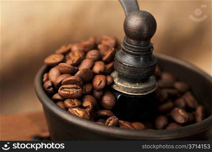Vintage manual coffee grinder with coffee beans isolated