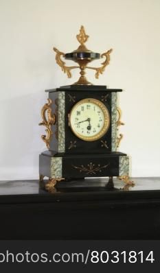 Vintage marble clock on black marble fireplace
