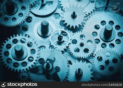 Vintage metal gears and cogs from old mechanism macro shot, blue color toned