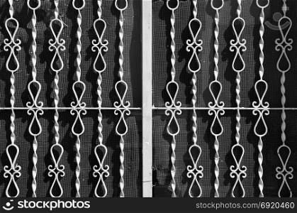 Vintage metal rails with abstract pattern and torn netting background. Black and white.