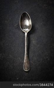 Vintage metal spoon on dark background
