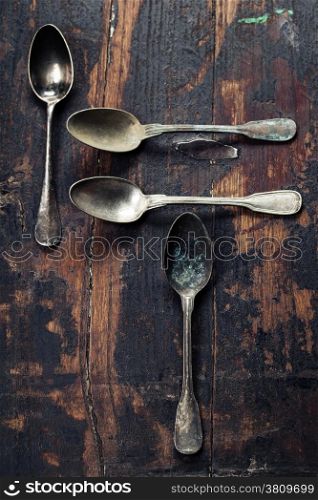 Vintage metal spoons on wooden background