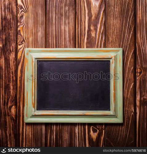 Vintage mini chalk board on the wooden background. Vintage chalk board
