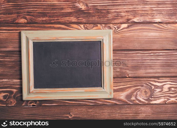 Vintage mini chalk board on the wooden background. Vintage chalk board