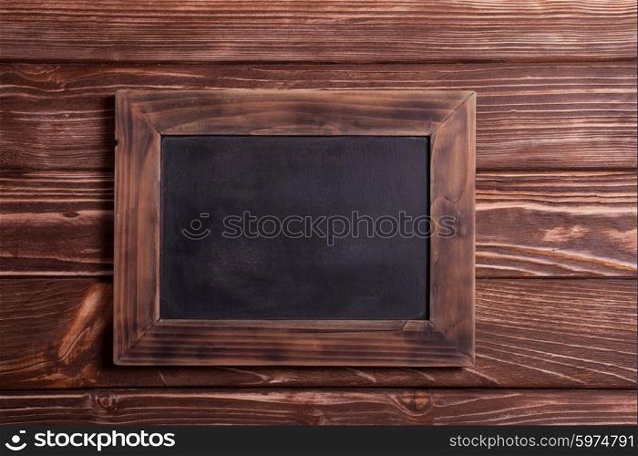 Vintage mini chalk board on the wooden background. Vintage chalk board