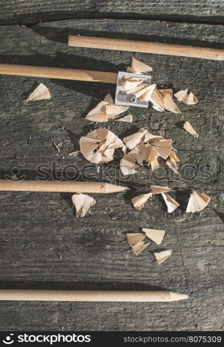 Vintage natural wooden pencils on dark wooden board