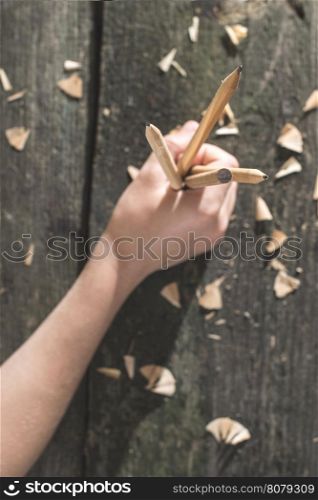 Vintage natural wooden pencils on dark wooden board
