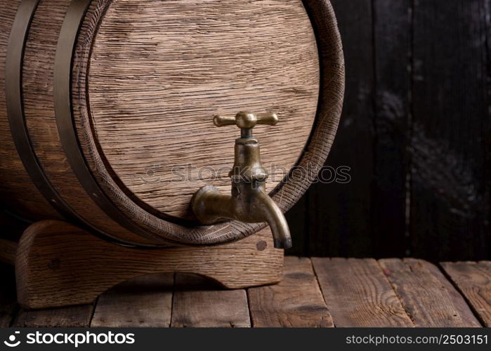 Vintage oak barrel on rack on old wooden table still life