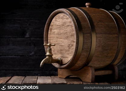 Vintage oak barrel on rack on old wooden table still life