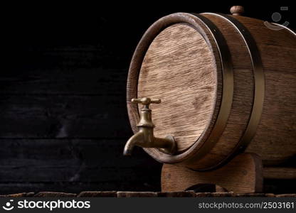 Vintage oak barrel on rack on old wooden table still life with copy space