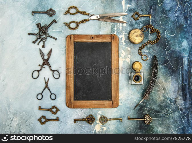 Vintage objects on old stone background. Creative flat lay with chalkboard