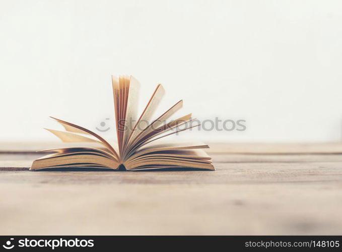 Vintage old books on wooden deck table background.