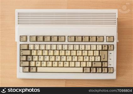 Vintage old computer from the 90&rsquo;s on wooden background