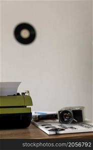 Vintage old film camera and typewriter at wooden desk table. Writer or screenwriter creative concept