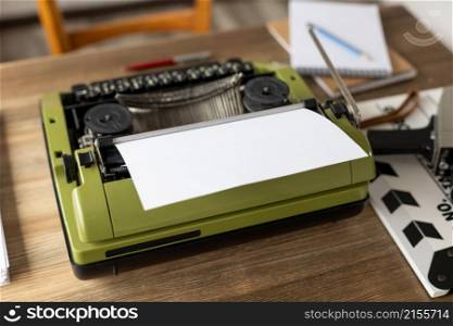 Vintage old film camera and typewriter at wooden desk table. Writer or screenwriter creative concept