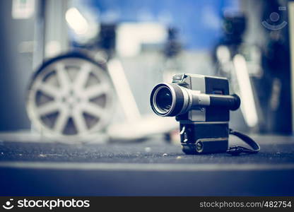 Vintage old movie camera, production studio in the blurry background