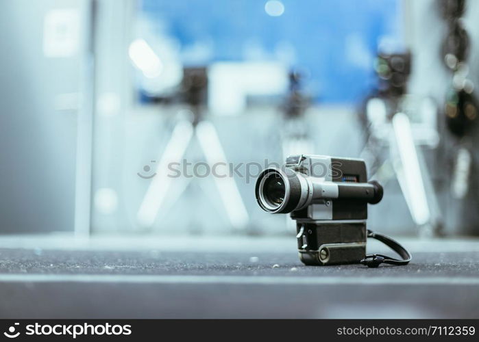 Vintage old movie camera, production studio in the blurry background