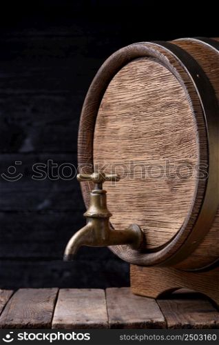 Vintage old oak barrel on rack on wooden table still life