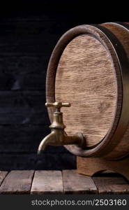 Vintage old oak barrel on rack on wooden table still life