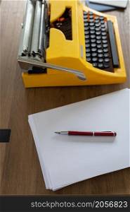 Vintage old typewriter at wooden desk table. Writer or screenwriter creative concept