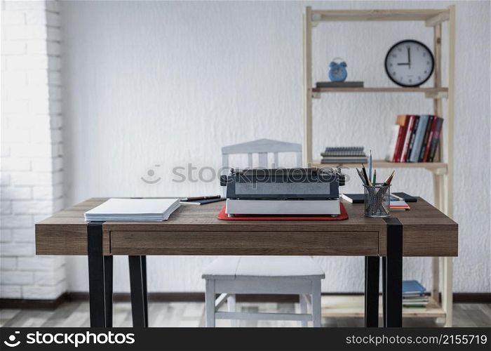 Vintage old typewriter at wooden desk table. Writer or screenwriter creative concept