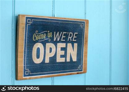 vintage open sign on blue wooden door