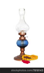 Vintage oriental gas or oil lamp with turkish amber rosary on white background