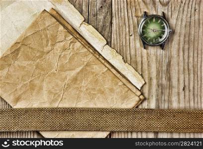 vintage paper and old broken watch on wooden boards