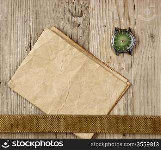 vintage paper and old broken watch on wooden boards
