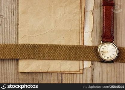 vintage paper and old broken watch on wooden boards