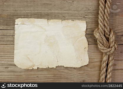 Vintage paper and rope on old wooden boards